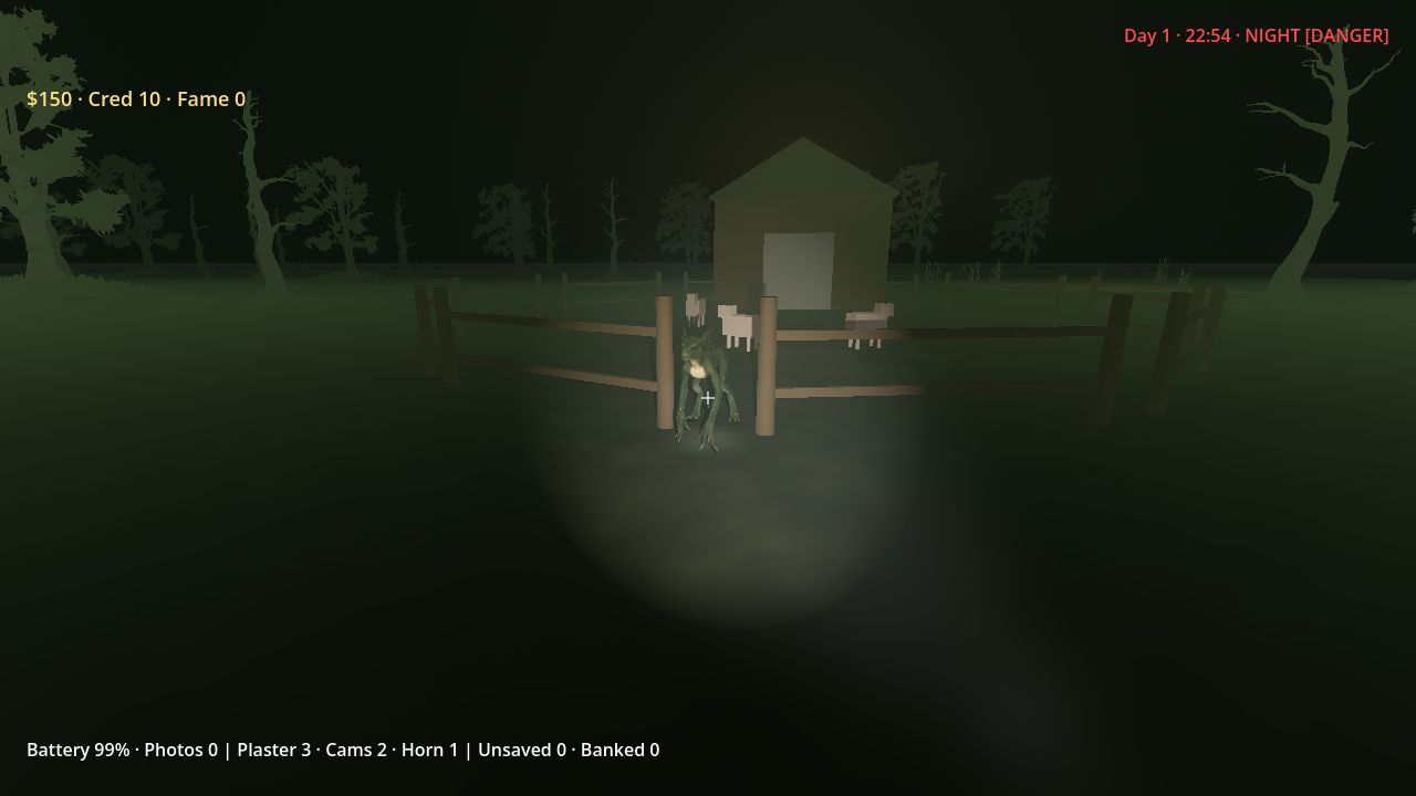 A wooden pen and shed lit by a flashlight at night