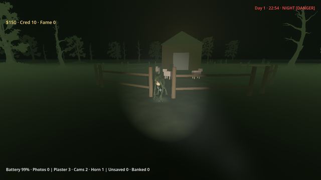 A wooden pen and shed lit by a flashlight at night